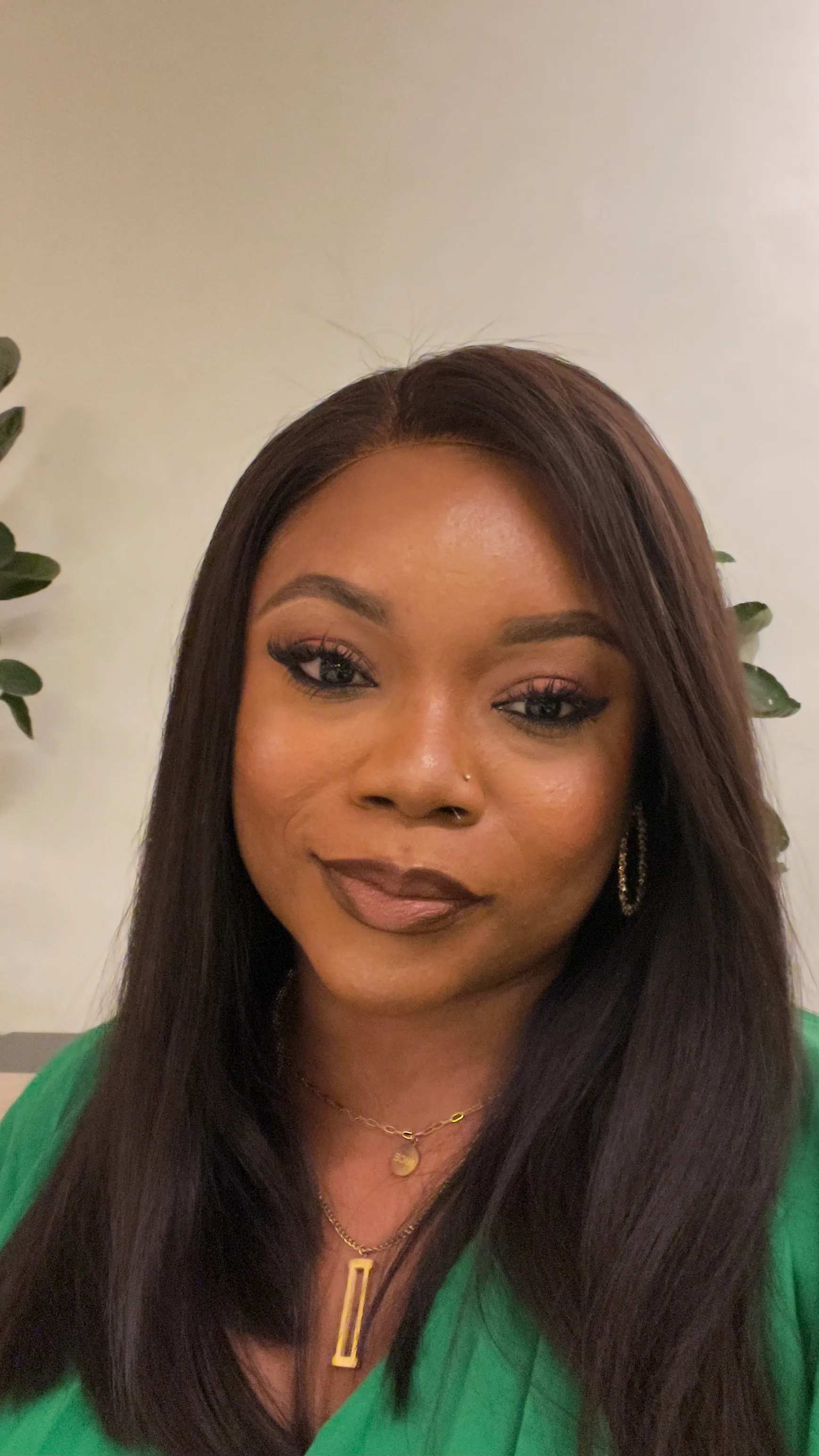 A photo of Oreoluwa Badmus in a green shirt with a smile on her face.