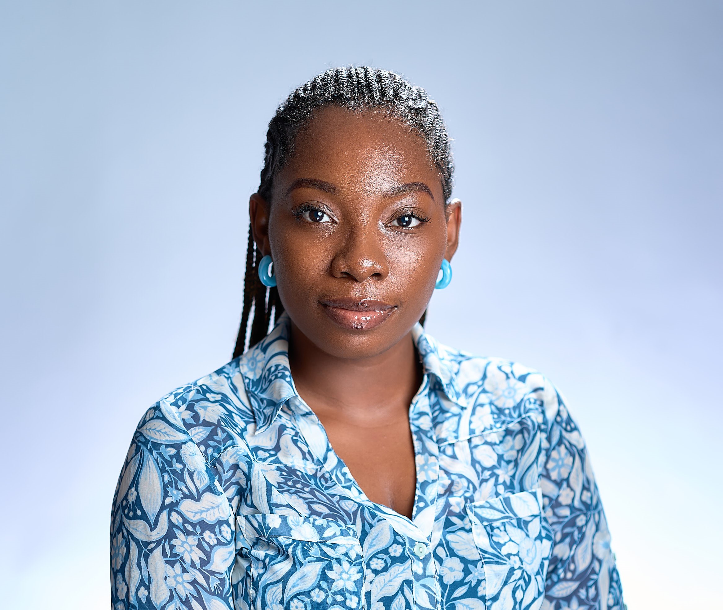 Oyinlola Olawale in a blue shirt posing for a picture.