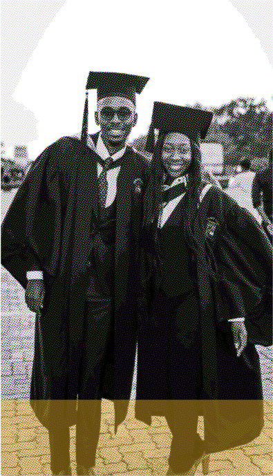 A couple of graduating students standing next to each other.