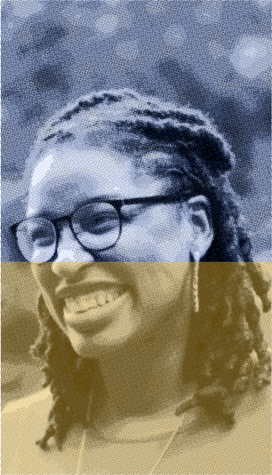 A woman with glasses is smiling for the camera.